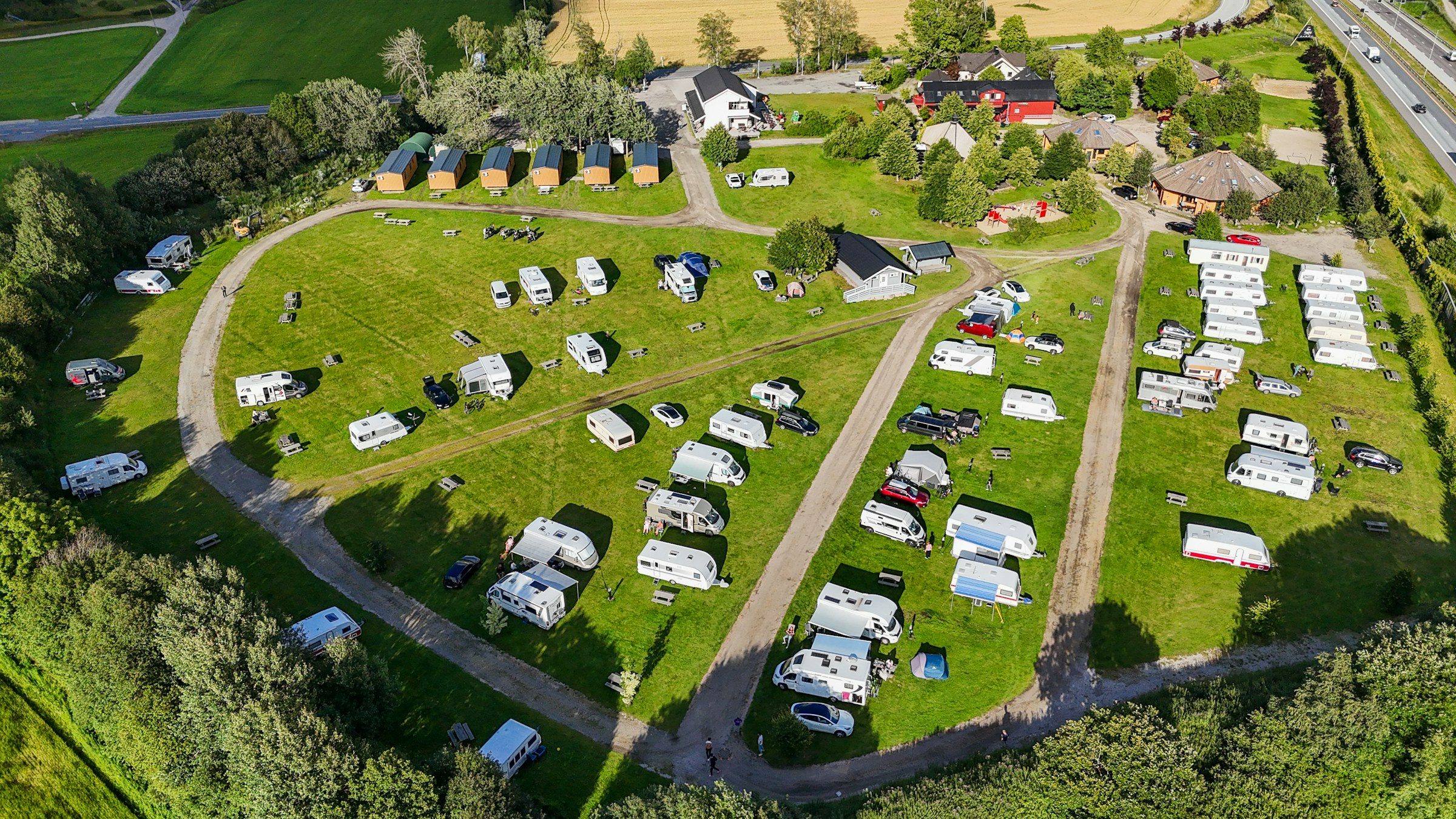 Aerial view of a campground with RV sites laid out among trees