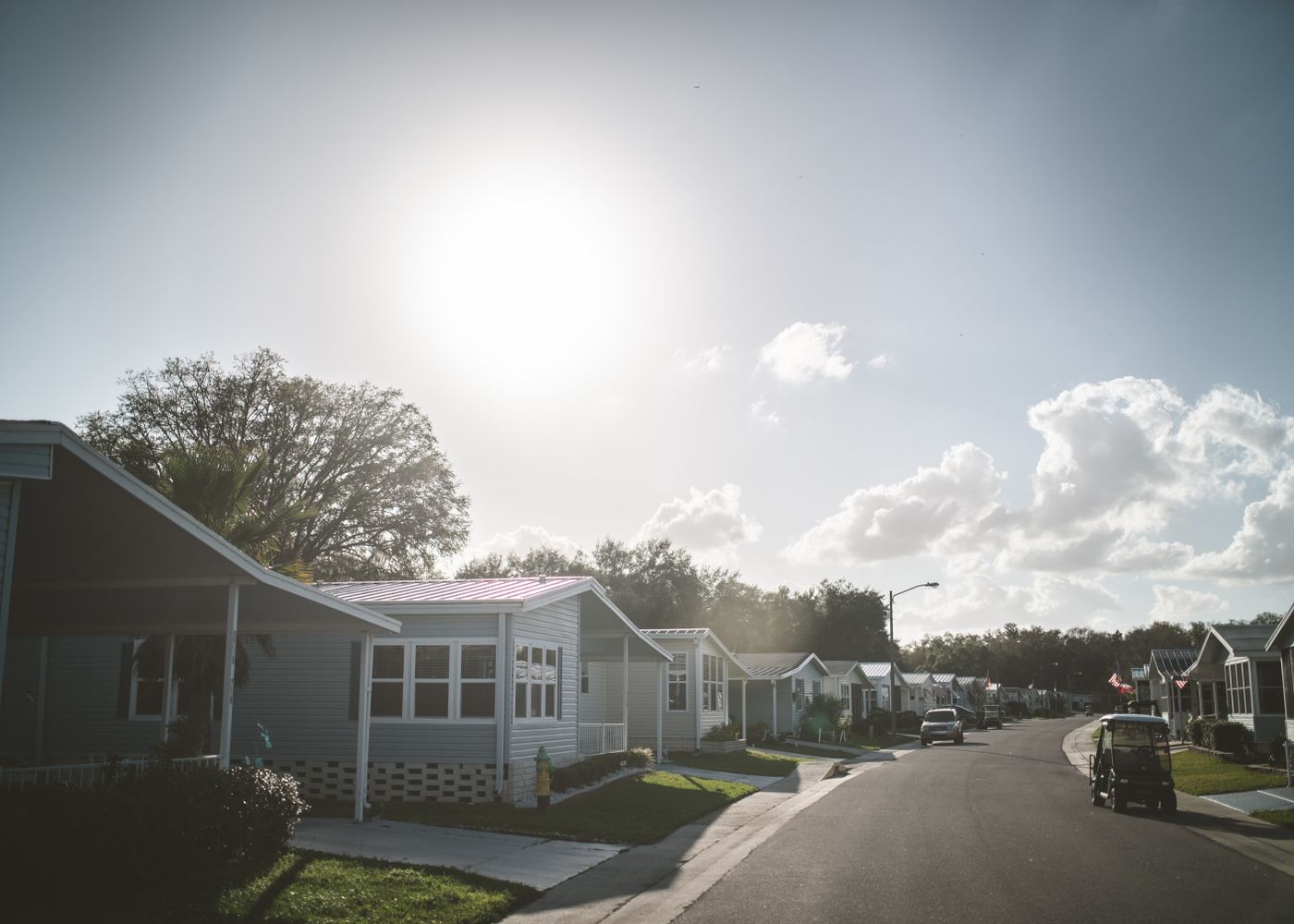 Manufactured housing community street with homes and lawns